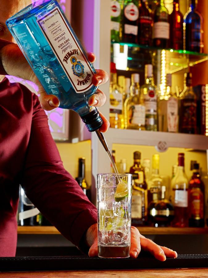 Cotswold Grange Bed & Breakfast Cheltenham Luaran gambar A bartender pouring a bottle of Blue Curaçao liqueur